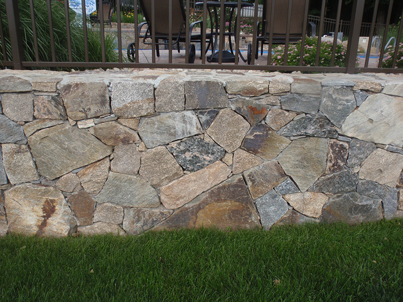 Natural stone wall project with premium masonry joints and finish control